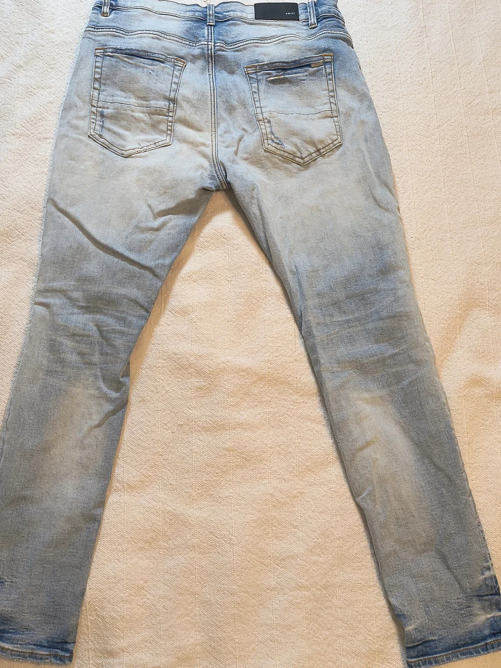 AMIRI Light Blue Distressed Jeans with Cherub Graphic